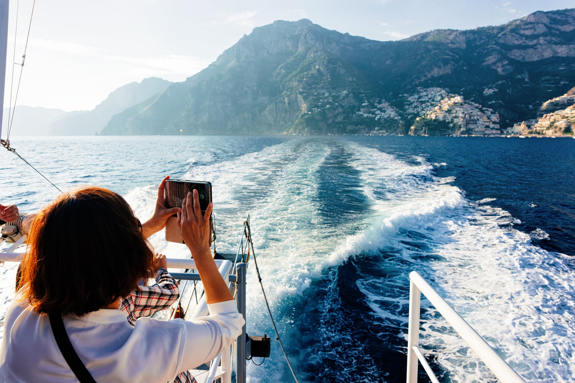 woman taking a photo on a boat woman taking a photo on a boat